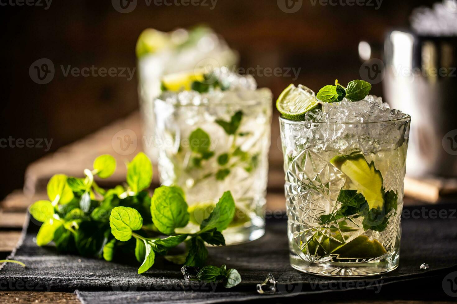 Mojito or virgin mojito long rum drink with fresh mint, lime juice, cane sugar and soda photo