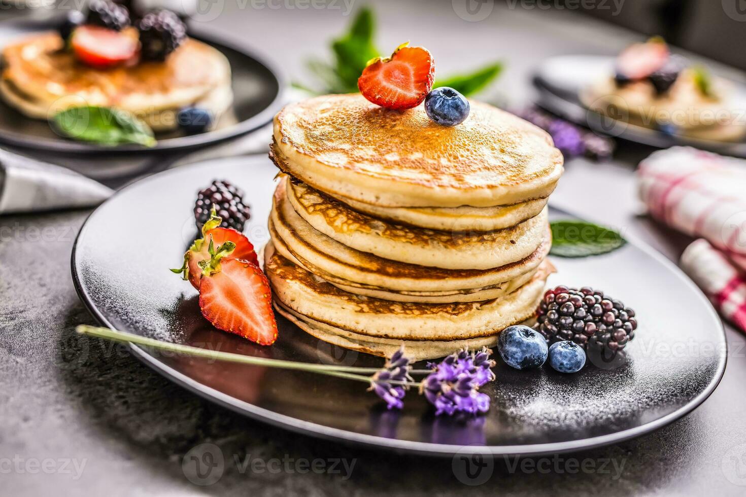 Pancakes with strawberries blackberries blueberries and levander. photo