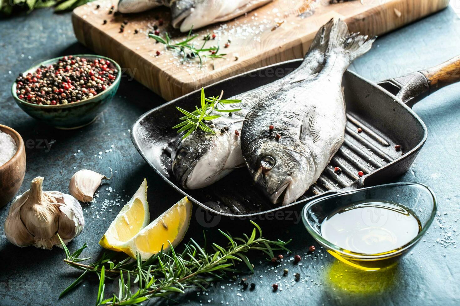 Mediterranean fish bream with spices salt herbs garlic and lemon. Healthy seafood. Concept of healthy sea food photo