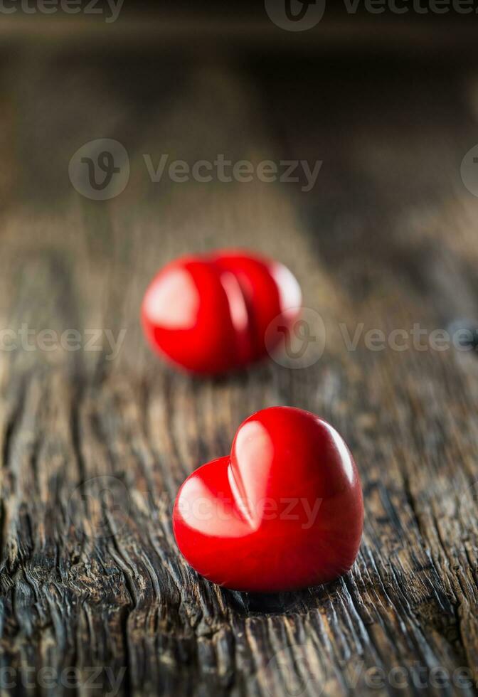 Valentines red heart. One two red heart on wooden table. Wedding or valentine day photo