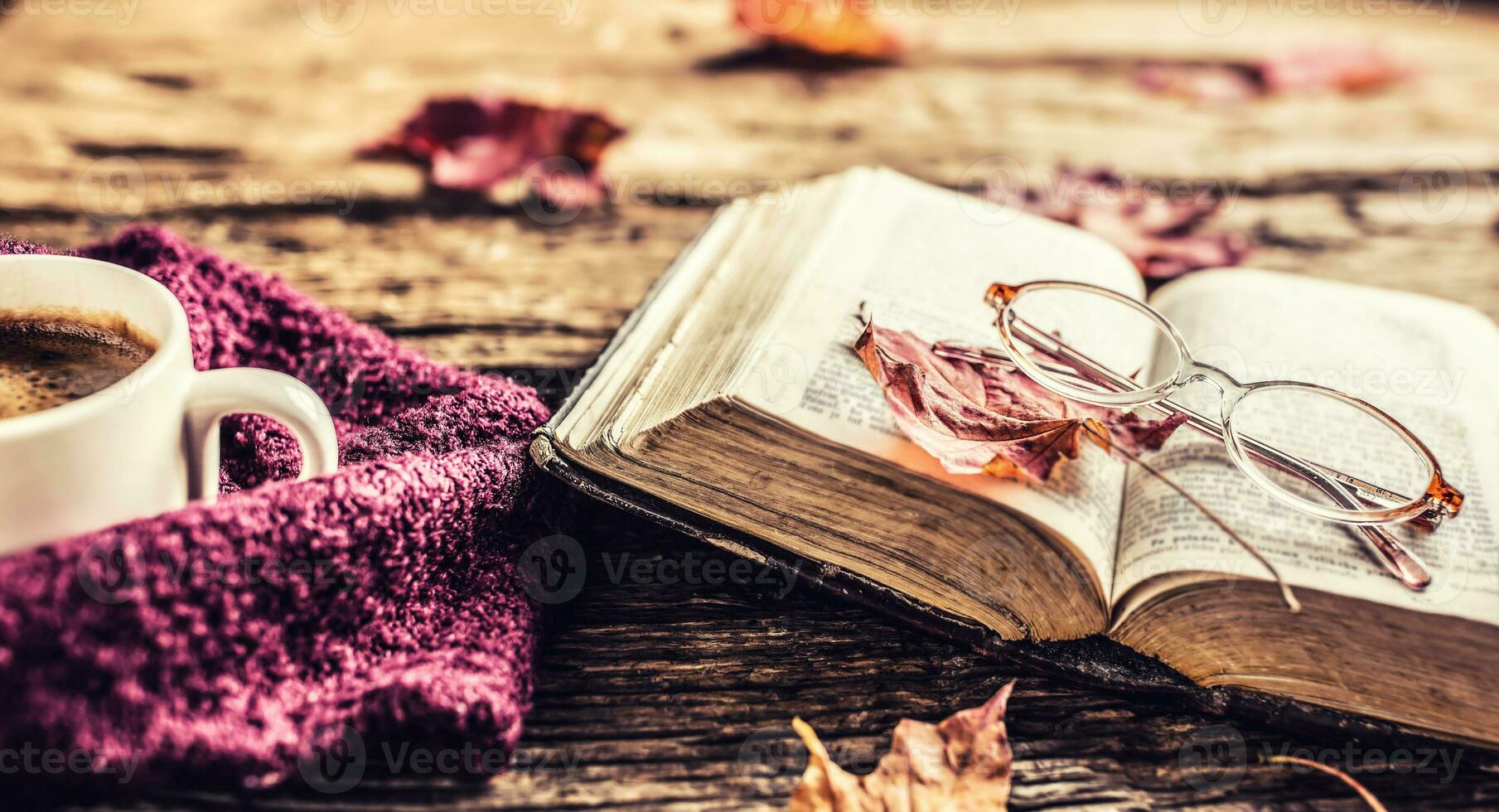 Cup of coffee old  book glasses and autumn leaves. photo