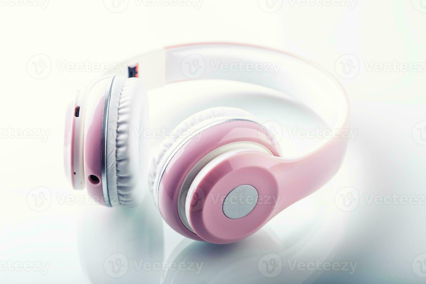 Headphones. Pink Headphones with jack connector - mirror reflection photo