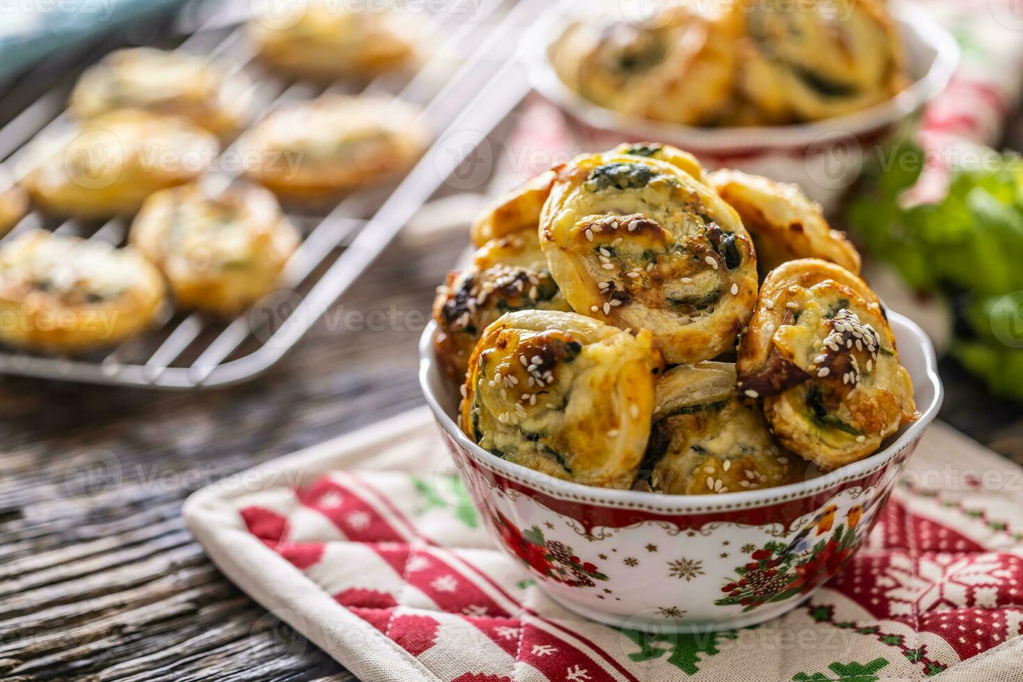 Christmas savory pastries, mini pizza cakes in a typical Christmas dish and festive decorations photo