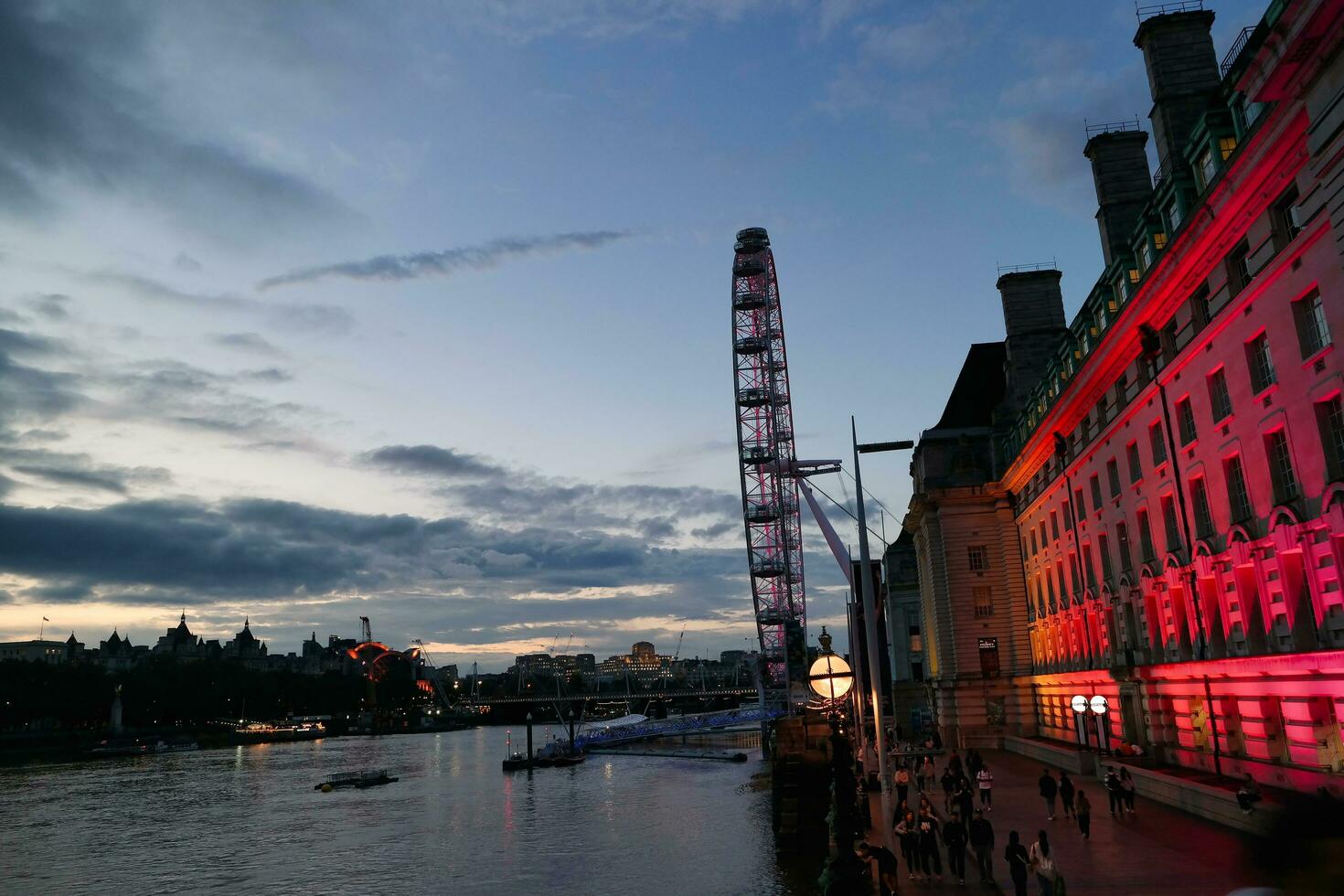 Most Beautiful Footage of Illuminated London eye from River Thames Westminster, Big Ben clock Tower at After Sunset Night. England Great Britain,  Footage Was Captured on Aug 02nd, 2023 After Sunset. photo