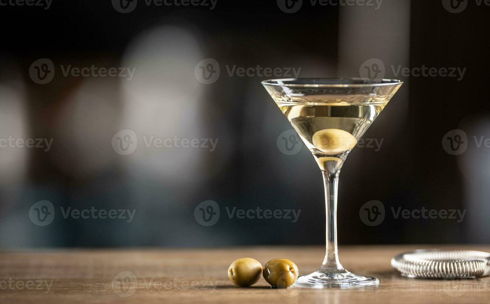 Dry Martini short drink cocktail with gin, dry vermouth and an olive garnish photo