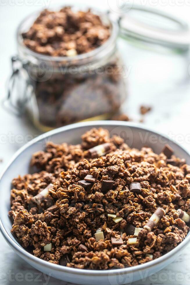 Jar of muesli with dark and milk cocolate pieces - closeup photo