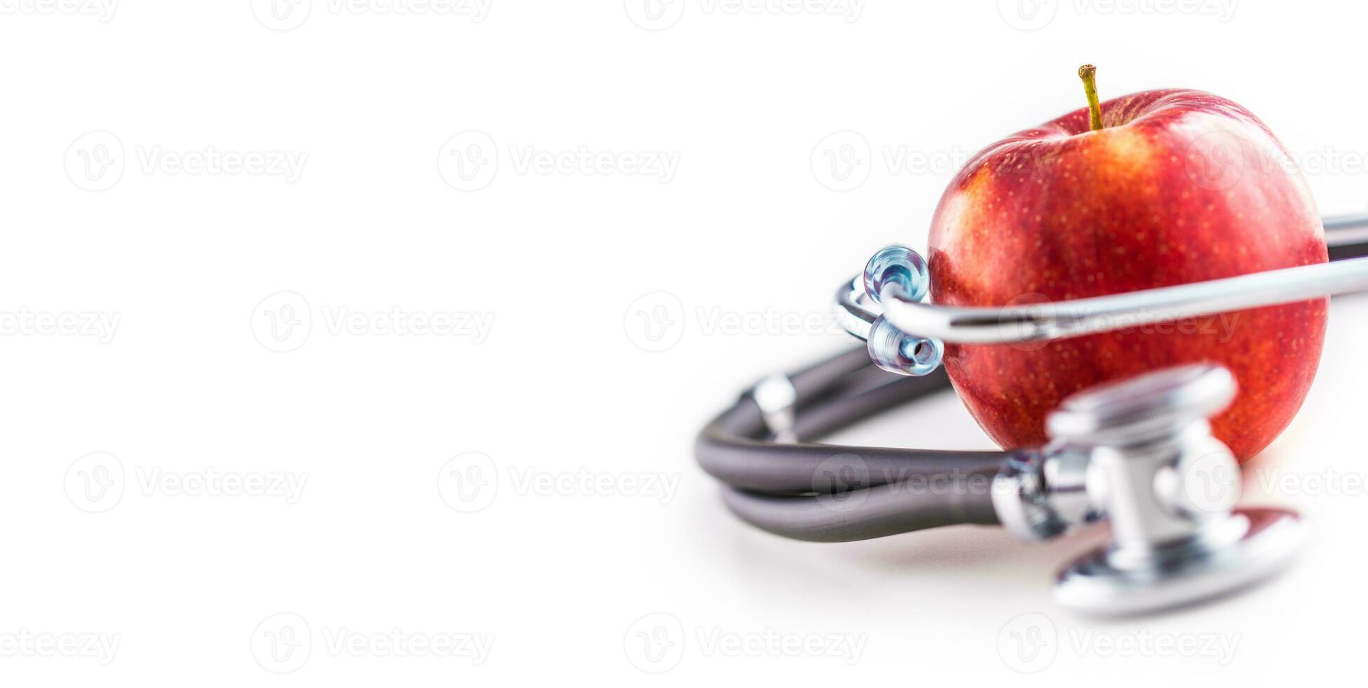 Close-up stethoscope and red apple  on white background photo