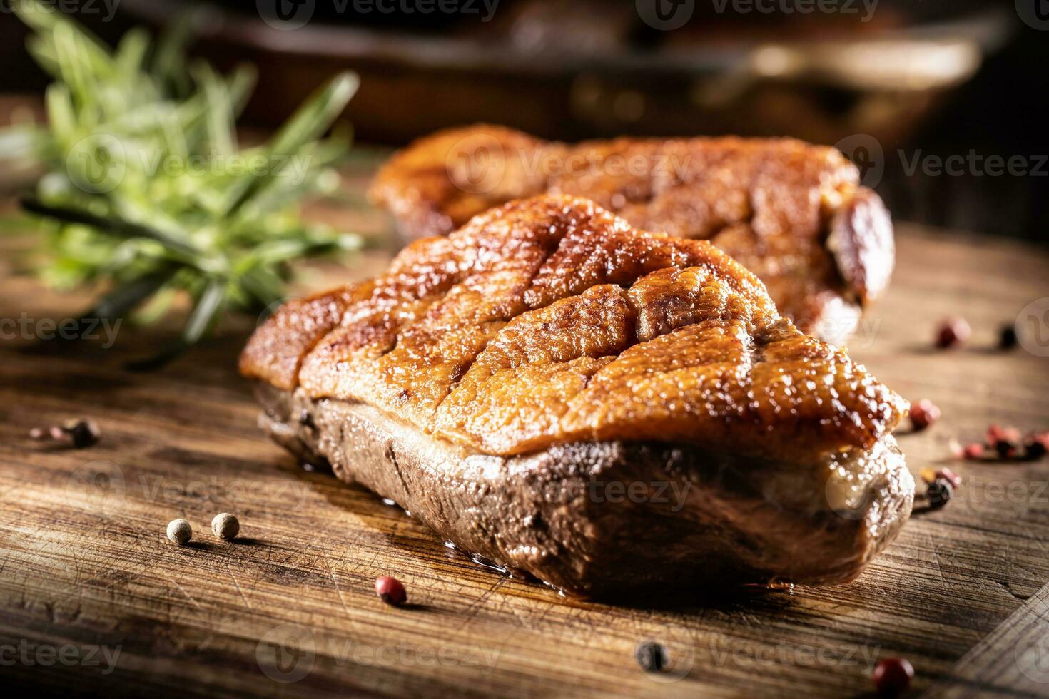 Roasted duck breast on a cutting board ready for slicing and serving photo