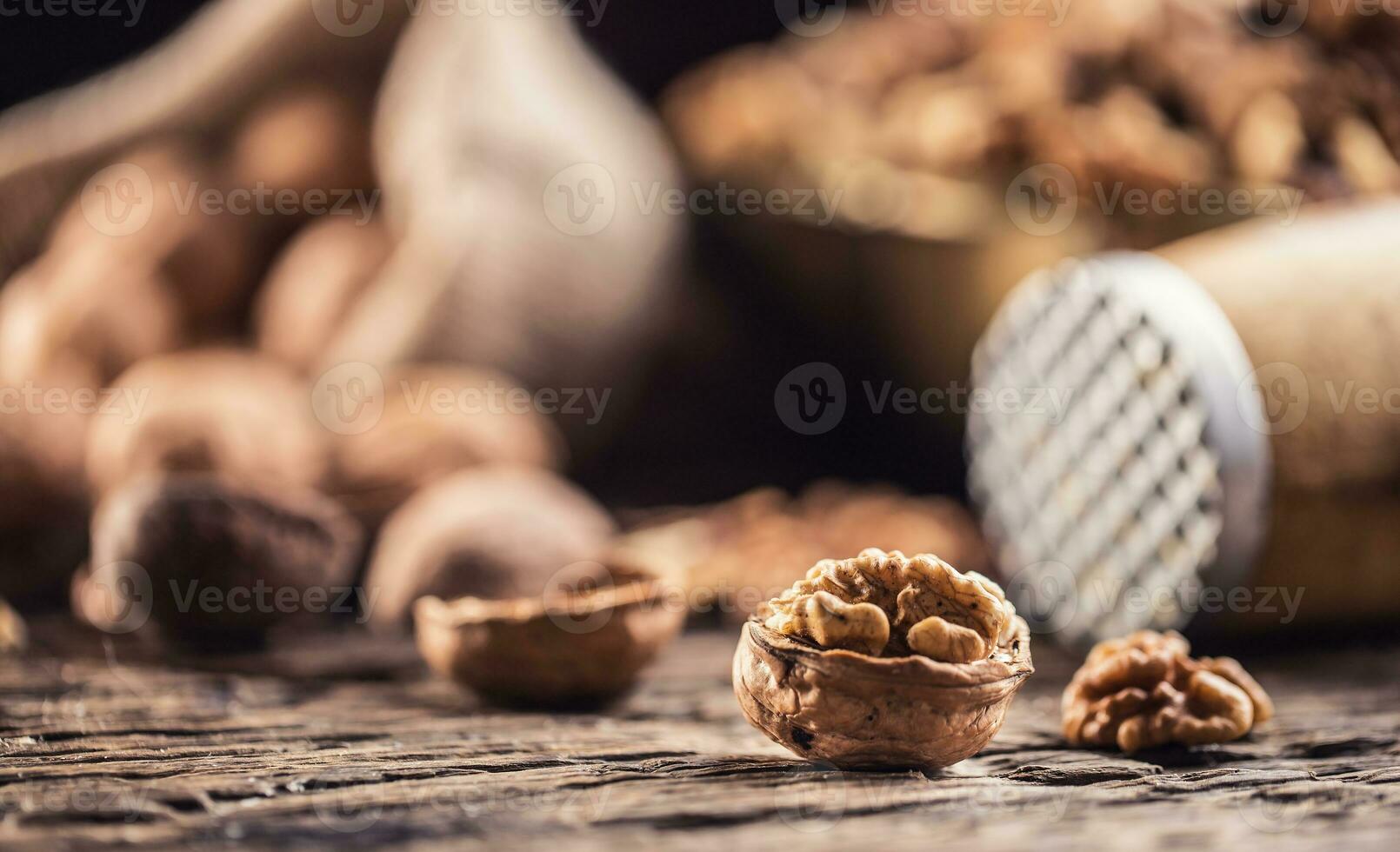 Walnut kernels whole walnuts in burlap sack and vintage bowl photo