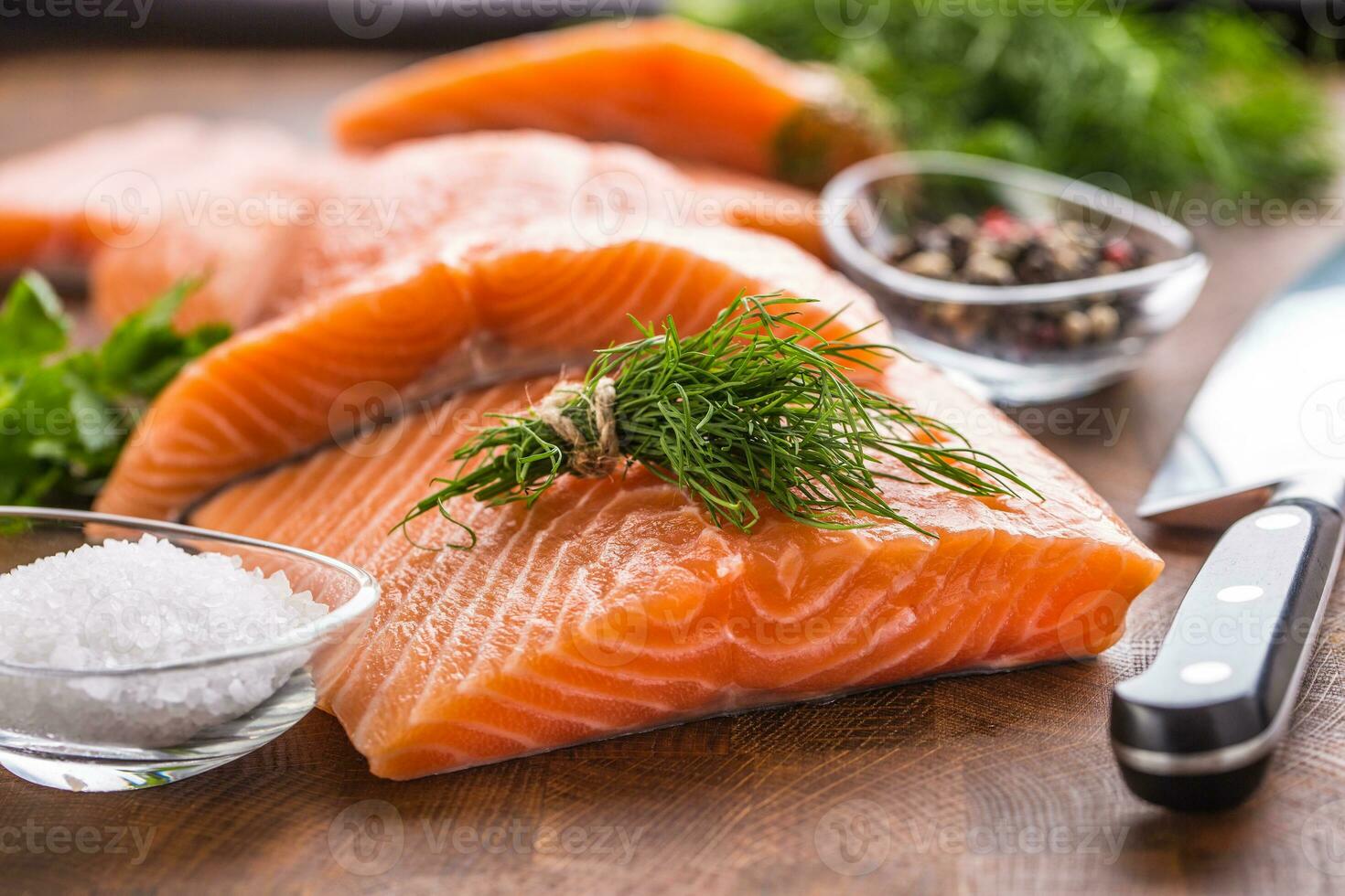 Raw salmon fillet with dill lemon olive oil salt and pepper photo