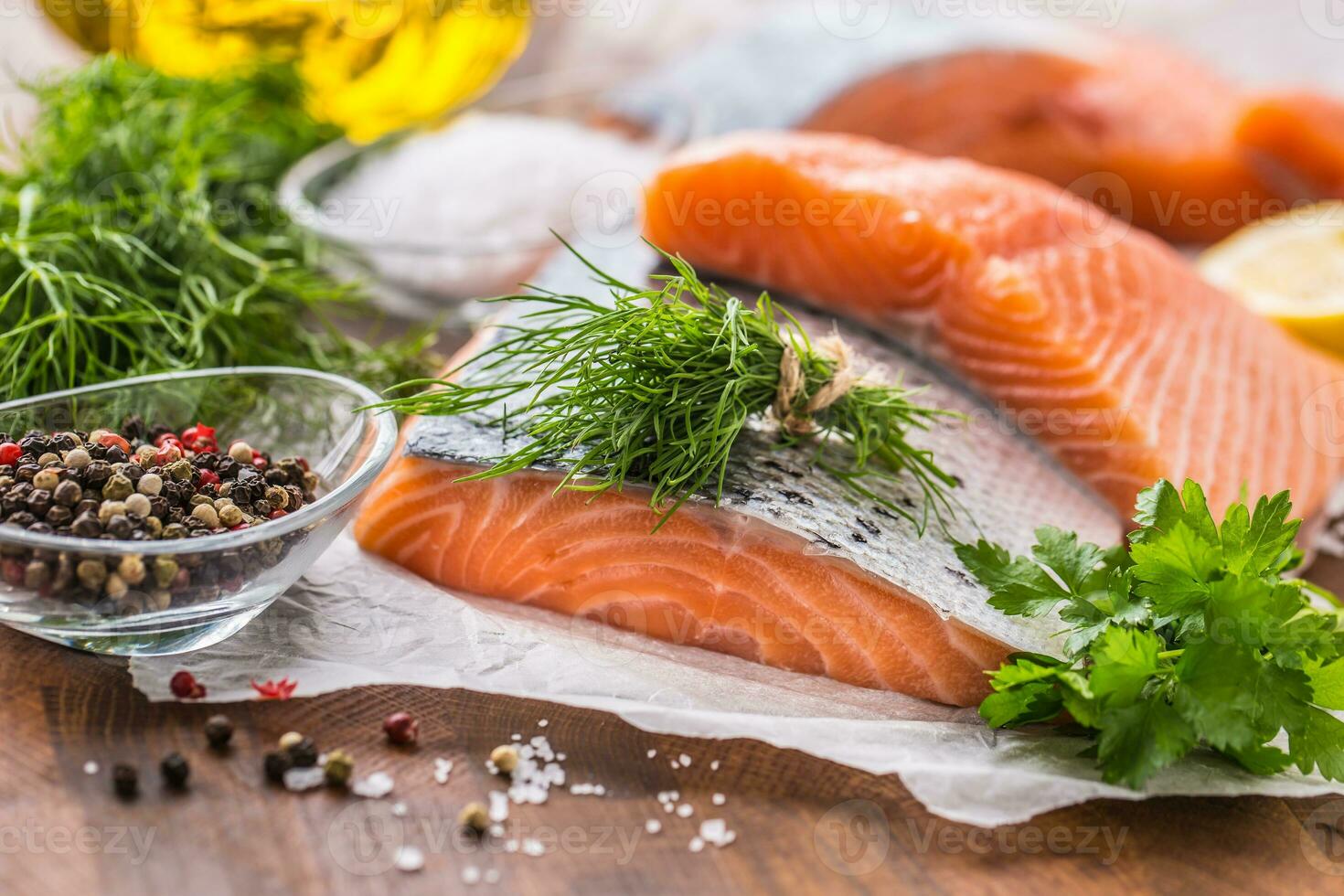 Raw salmon fillet with dill lemon olive oil salt and pepper photo