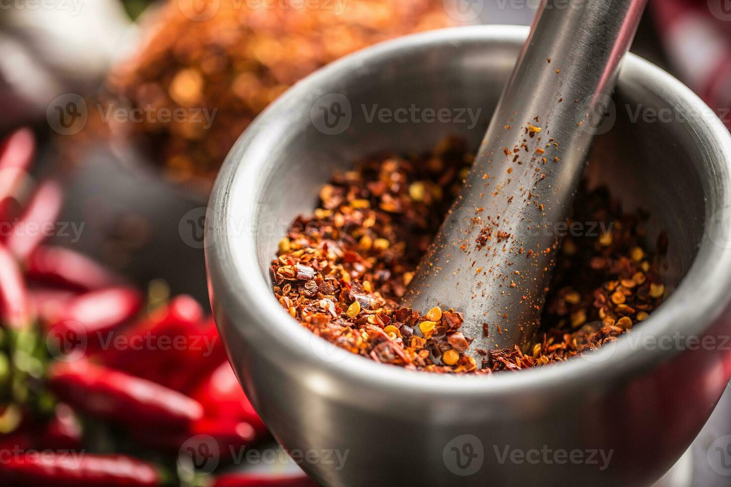Dried ground chili in mortar close up photo