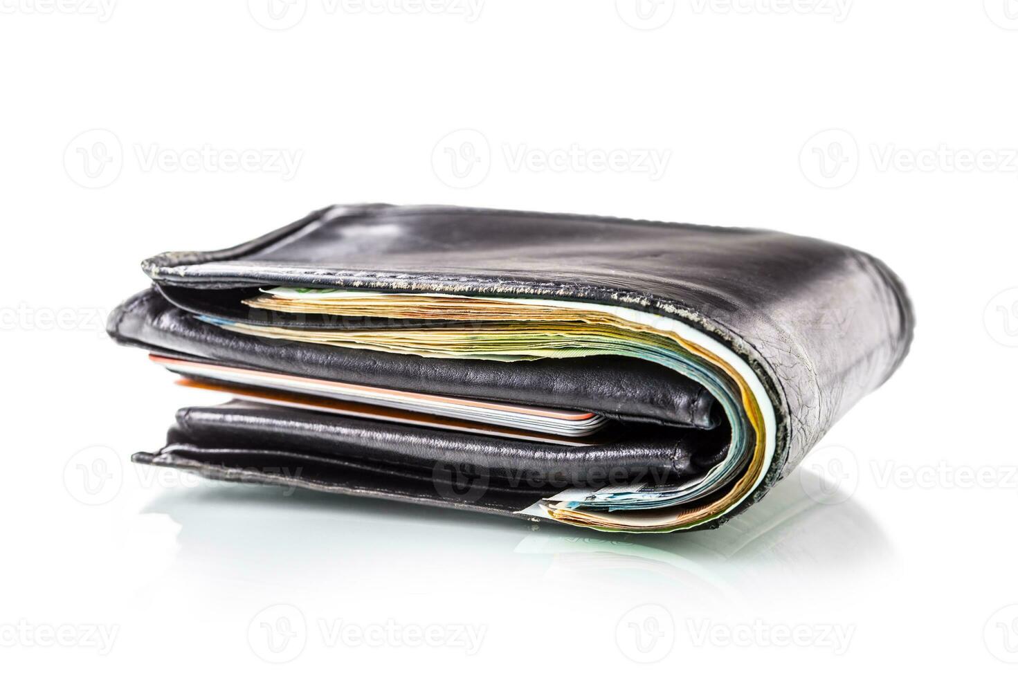Wallet full of banknotes and credit cards isolated on white with mirror reflection photo