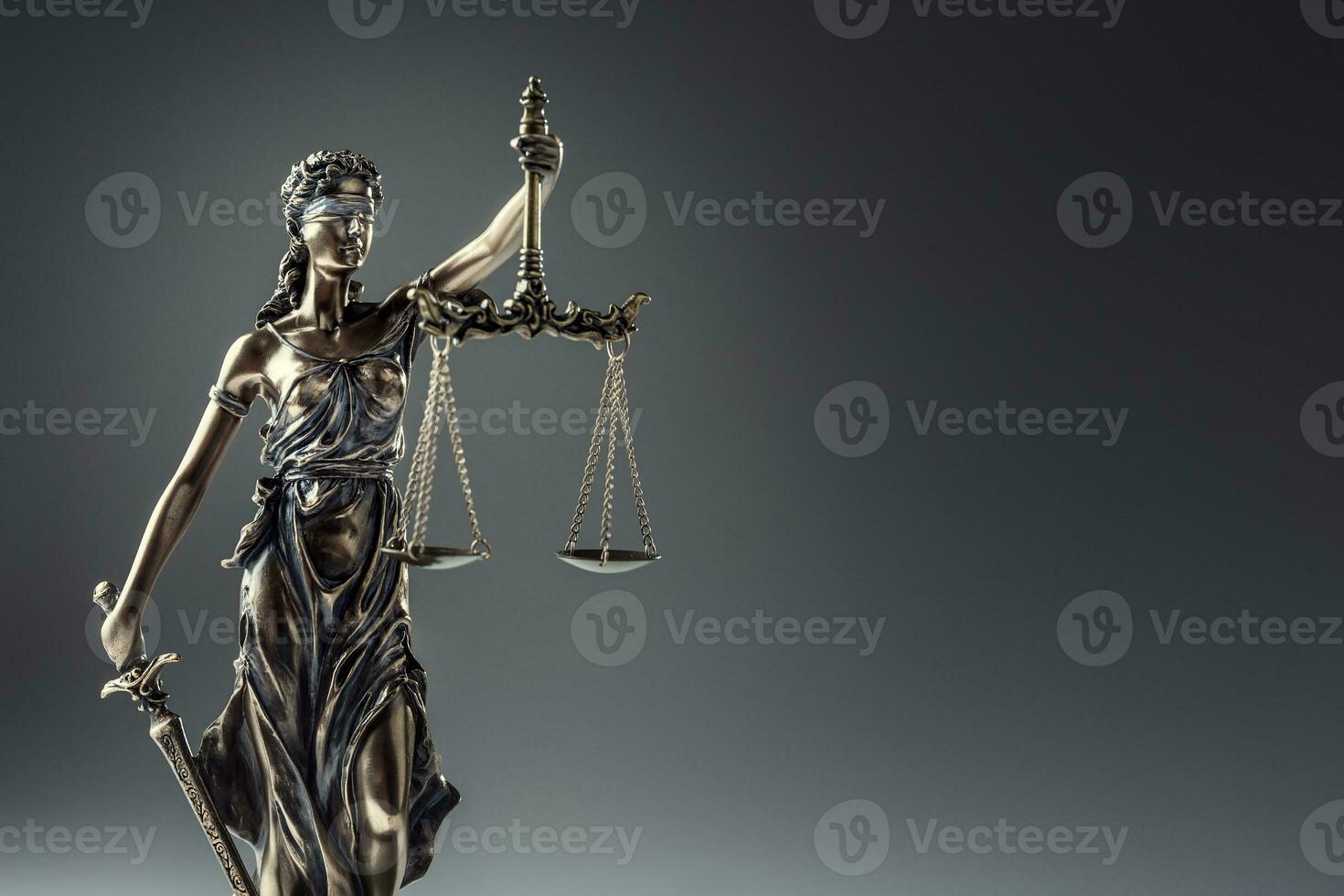 Statute of Justice. Bronze statue Lady Justice holding scales and sword photo