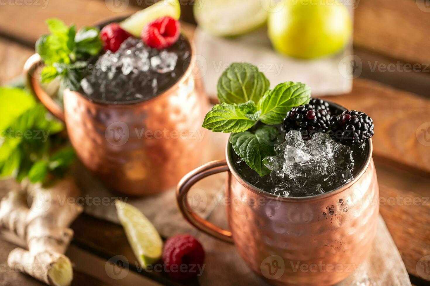 Moscow Berry Mule highball vodka cocktail is a long drink with fresh lime juice, ginger beer and berries photo