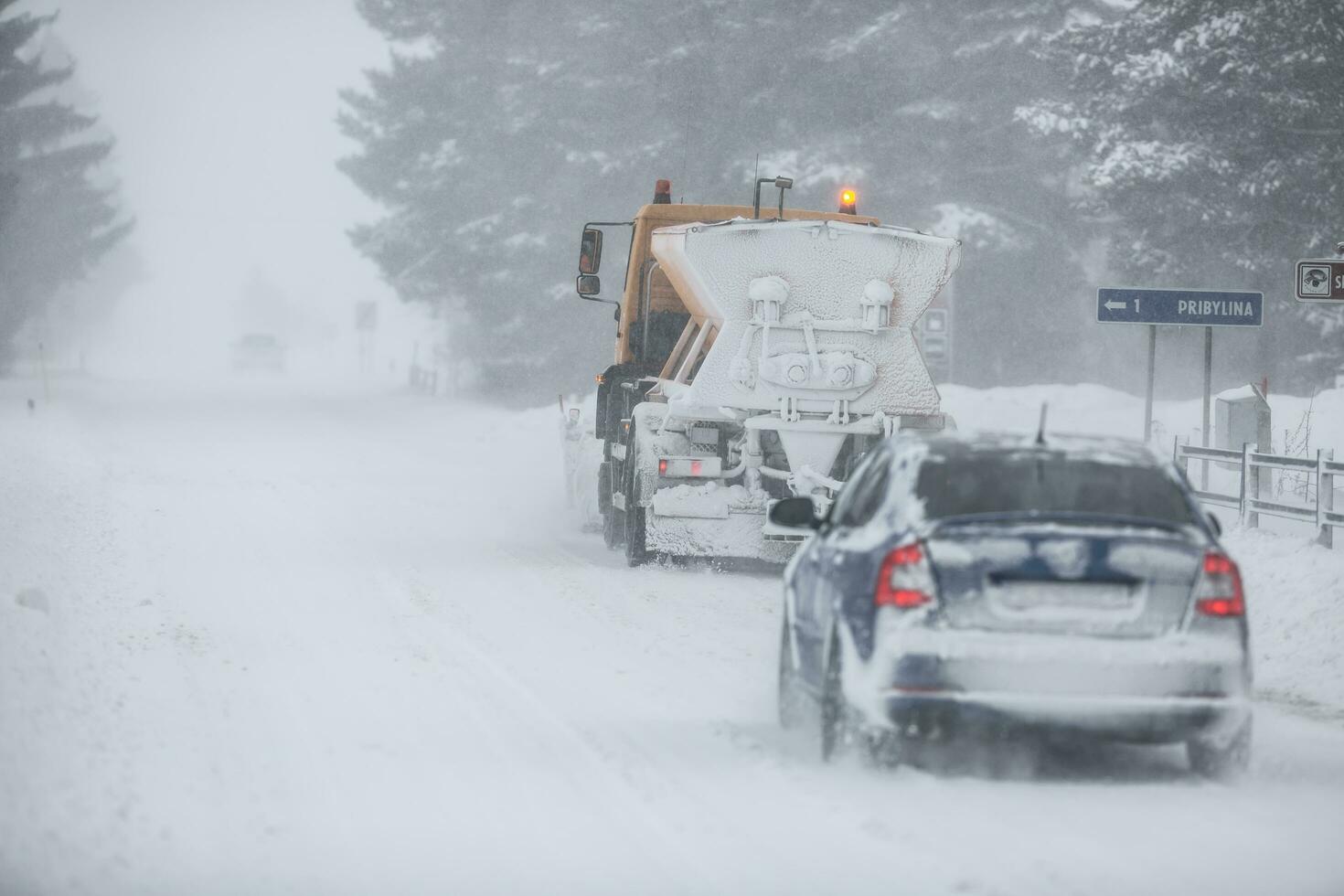 Liptov, Slovakia - JANUARY 30, 2022. The snow plow clears the way for the cars behind it photo