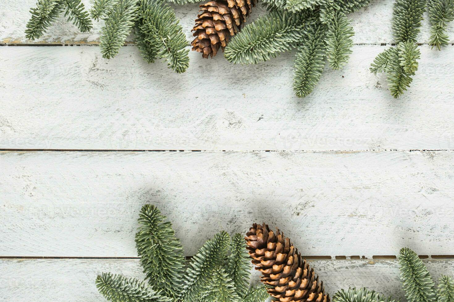 Christmas background twigs and pine cone on wooden background - Top of view photo