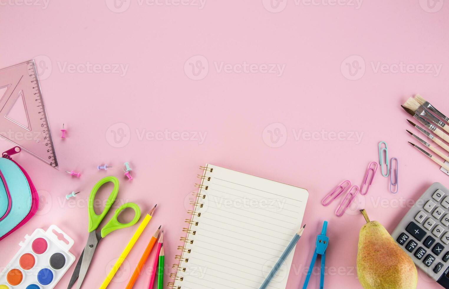School supplies with copy space on pink background photo