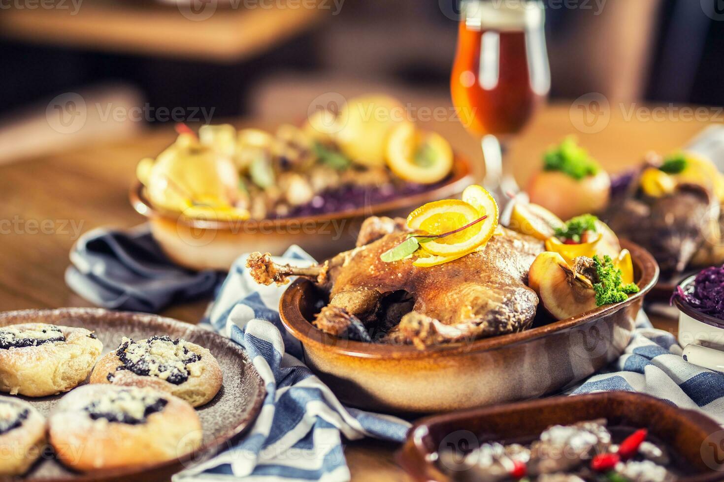 Roasted christmas duck red cabbage dumplings liver draft beer and baked buns. photo