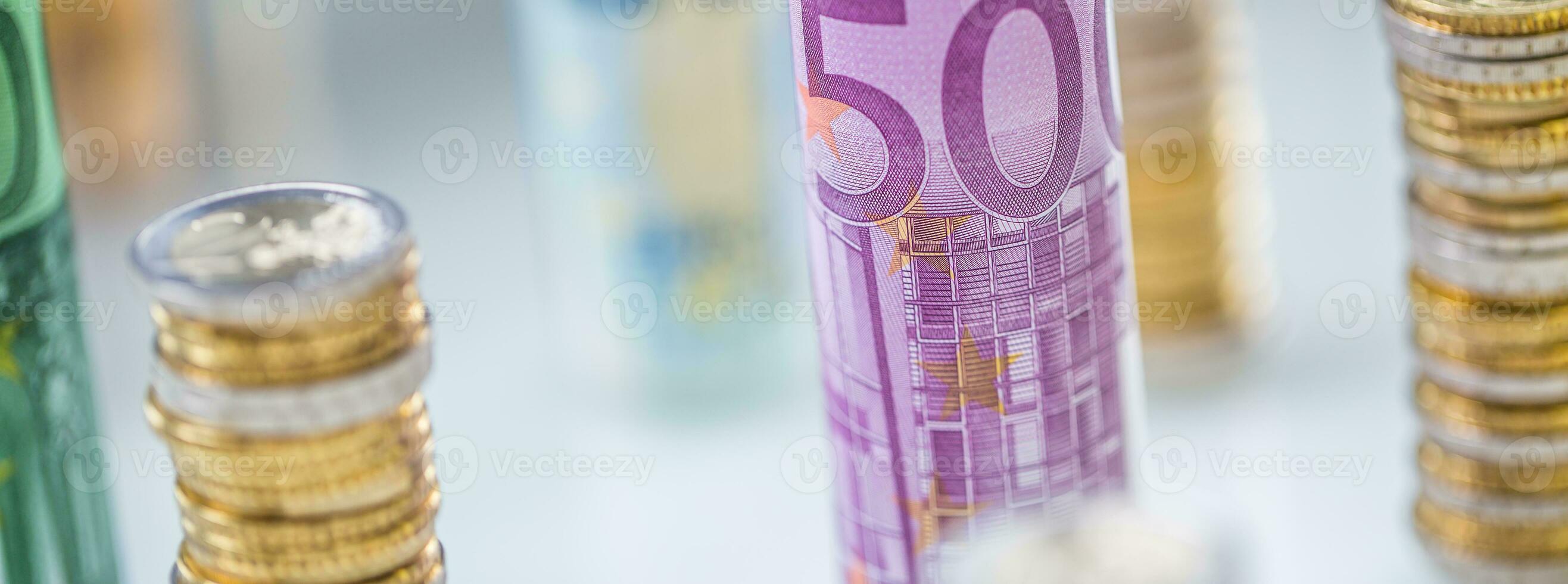 Rolled euro banknotes and coins towers stacked in other positions photo