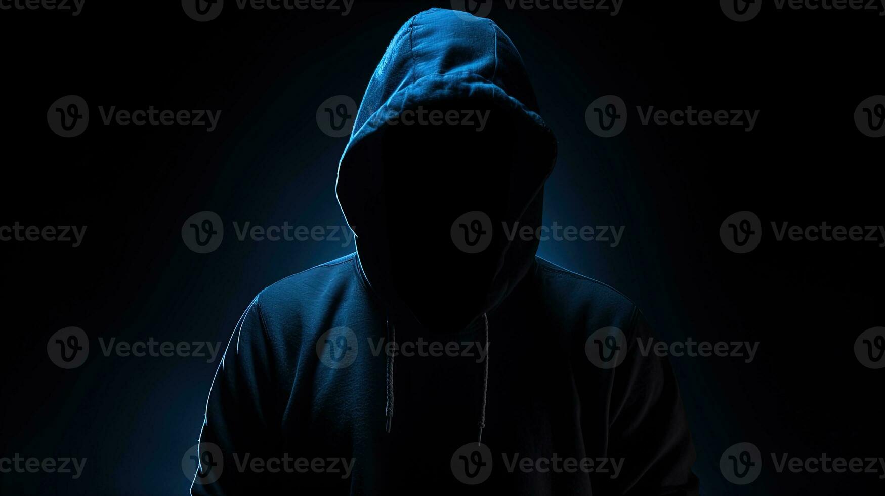 Unrecognizable figure in dark blue hoodie concealed face arms crossed solitary in darkness. silhouette concept photo