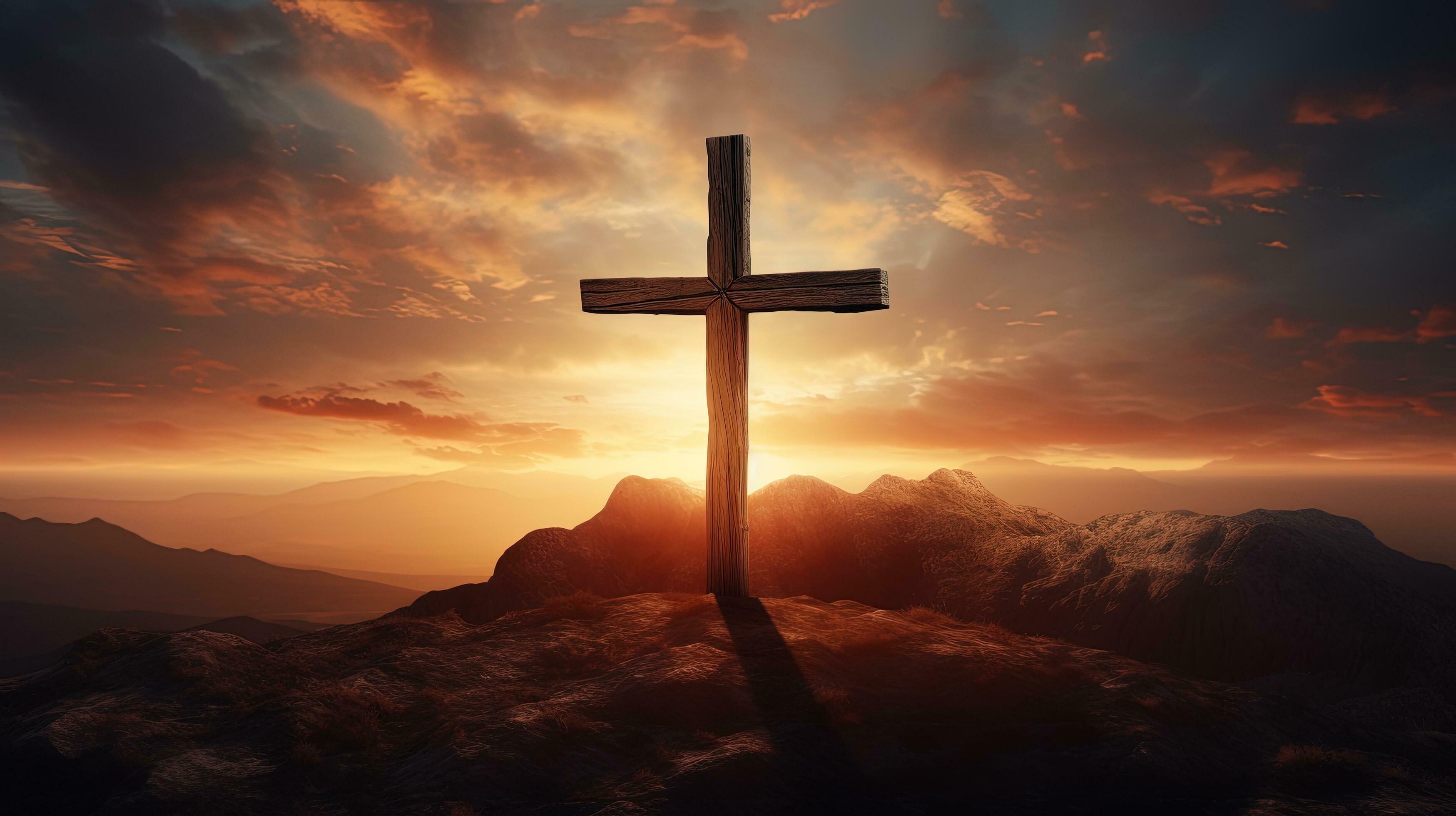 Jesus Christ crucified on a mountaintop at sunset serves as an abstract ...