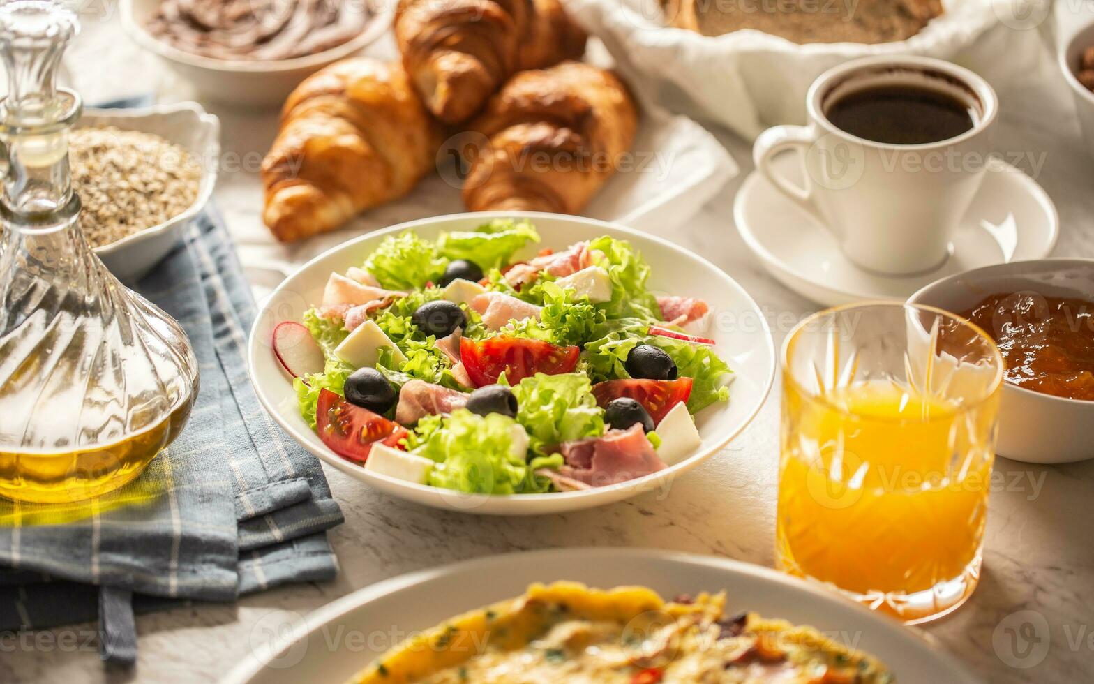 Broad assortment of food and drinks served for breakfast on a table photo