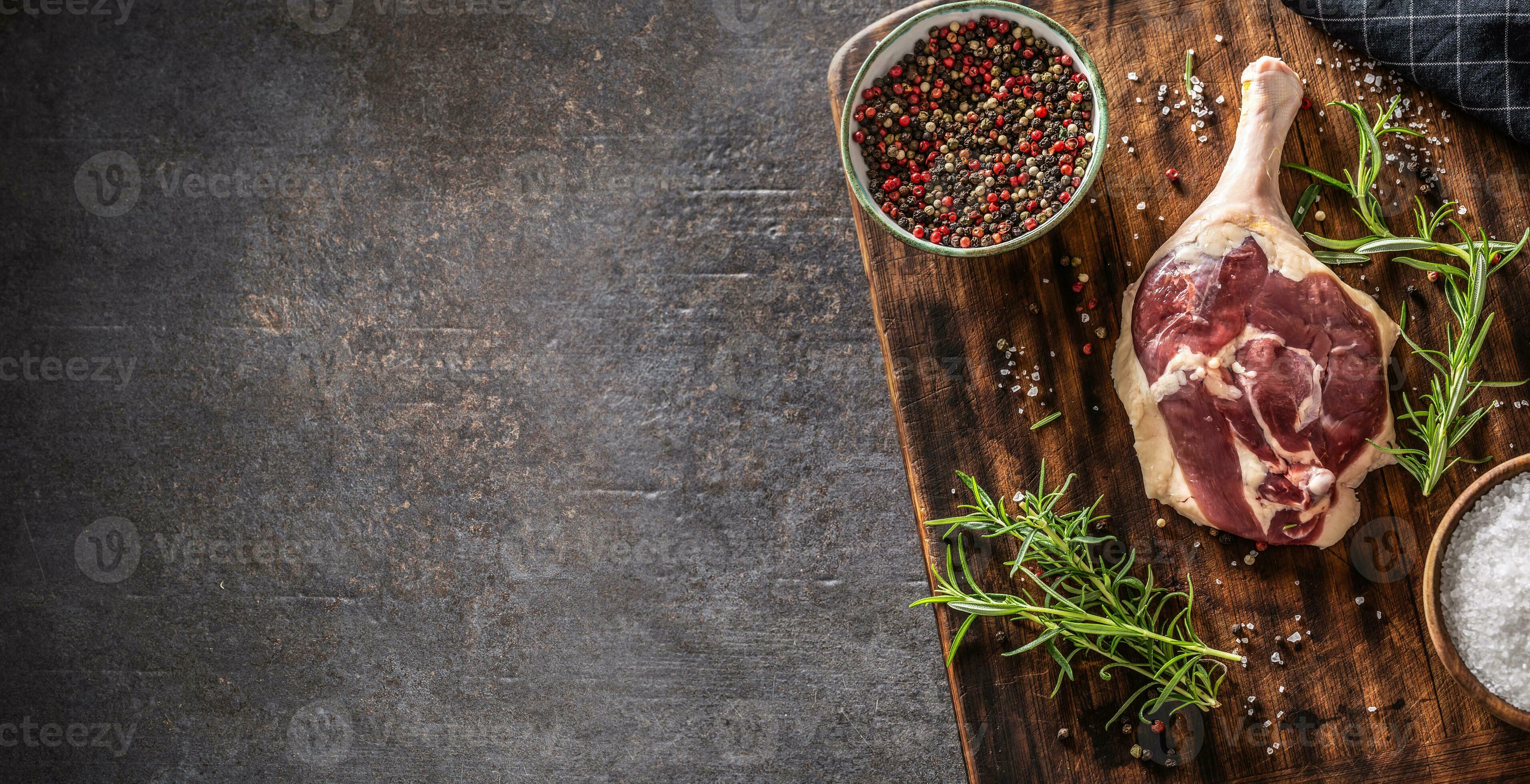 Top view of duck leg preparaton in a dark rustic environment with