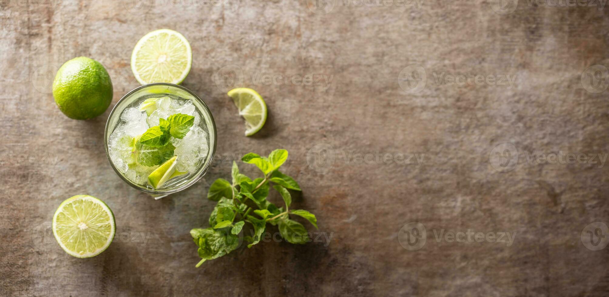 Mojito cocktail drink with white rum lime mint herbs and soda on the bar counter. photo