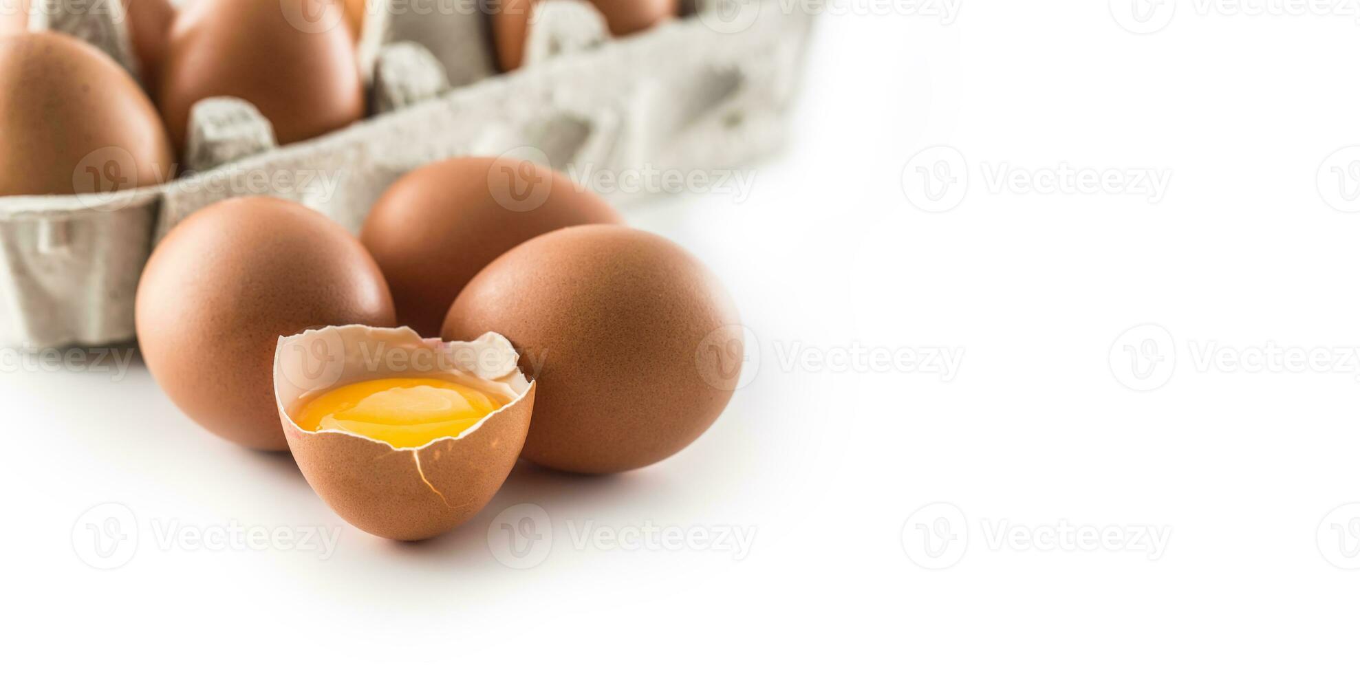 Chicken eggs and broken egg with yolk isolated on white background photo