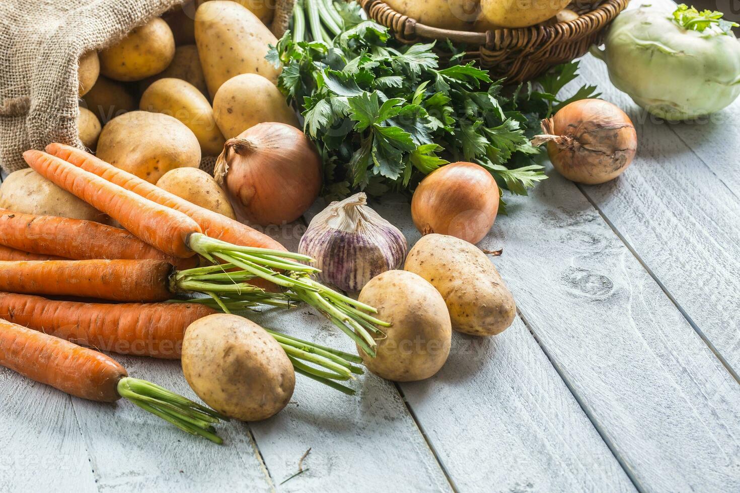 Potatoes onion carrot celery kohlrabi and garlic. photo