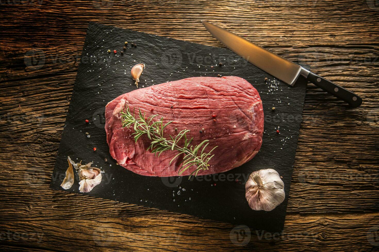 Beef steak. Raw Flank steak with rosemary garlic salt and pepper. photo