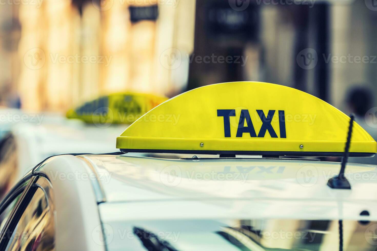 Taxi car waiting passengers in town.Taxi light on the cab of the car ready to transport the passengers photo