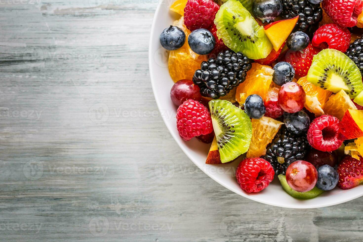 Fruit fresh mixed tropical fruit salad. Bowl of healthy fresh fruit salad - died and fitness concept. photo