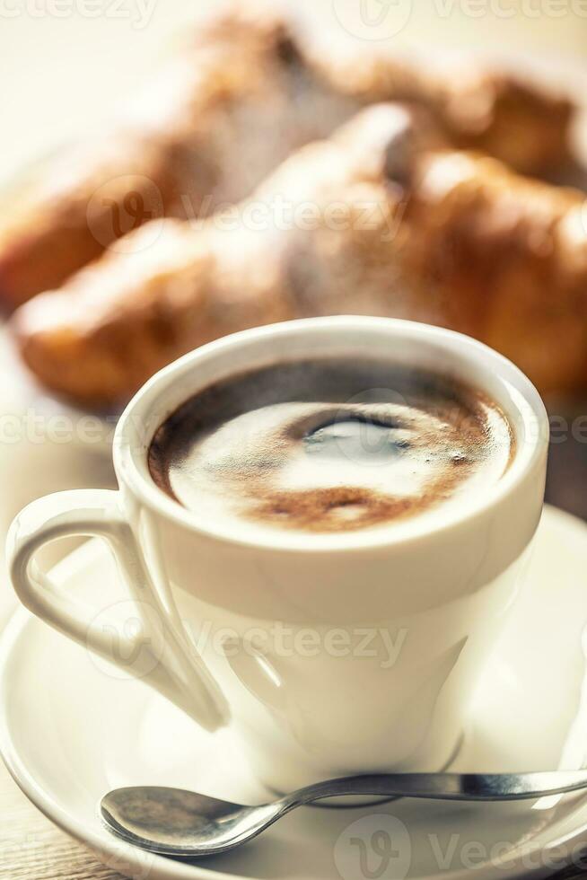 Cup of coffee and fresh croissants - italian or mediterranean breakfast photo