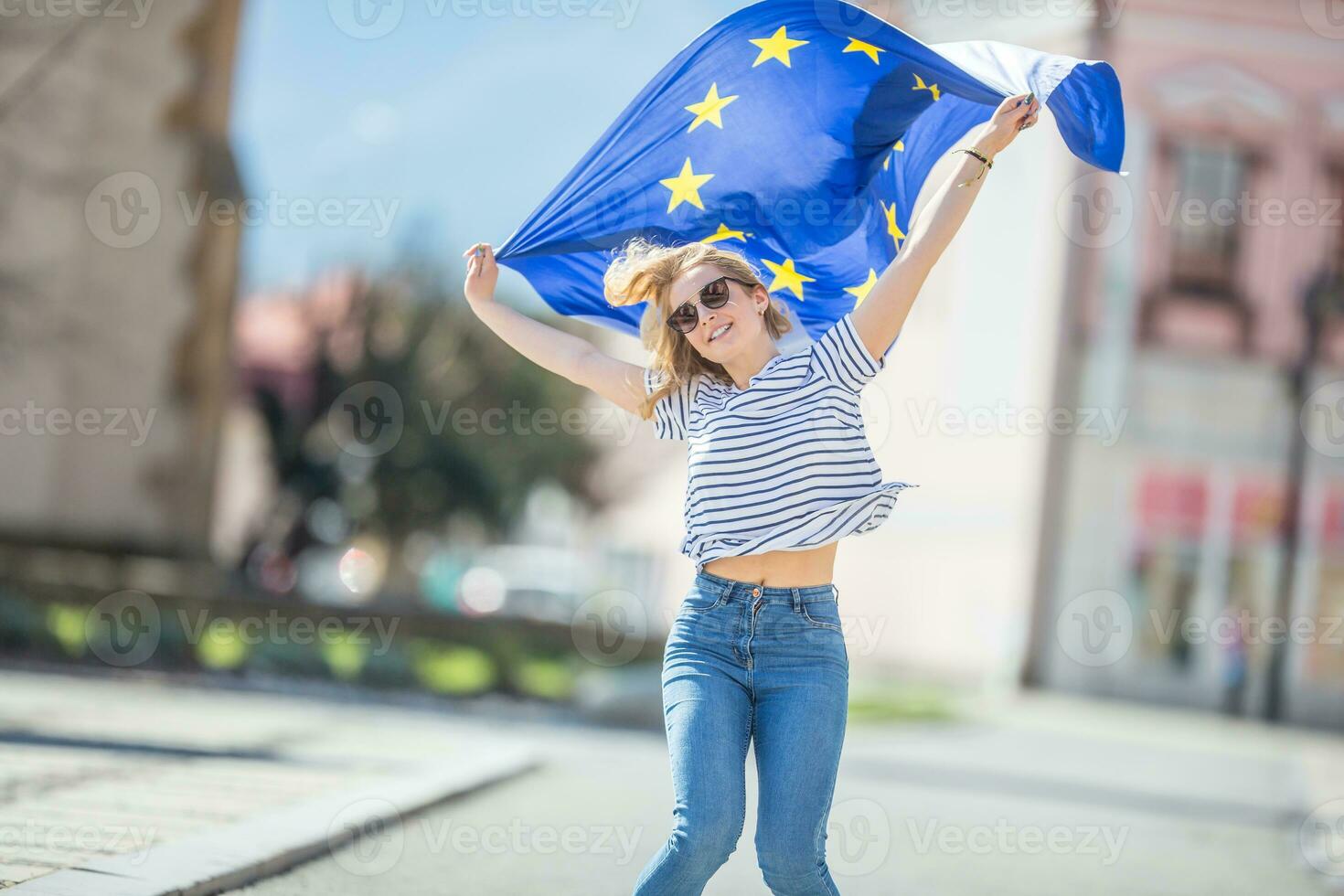 Attractive happy young girl with the flag of the European Union photo