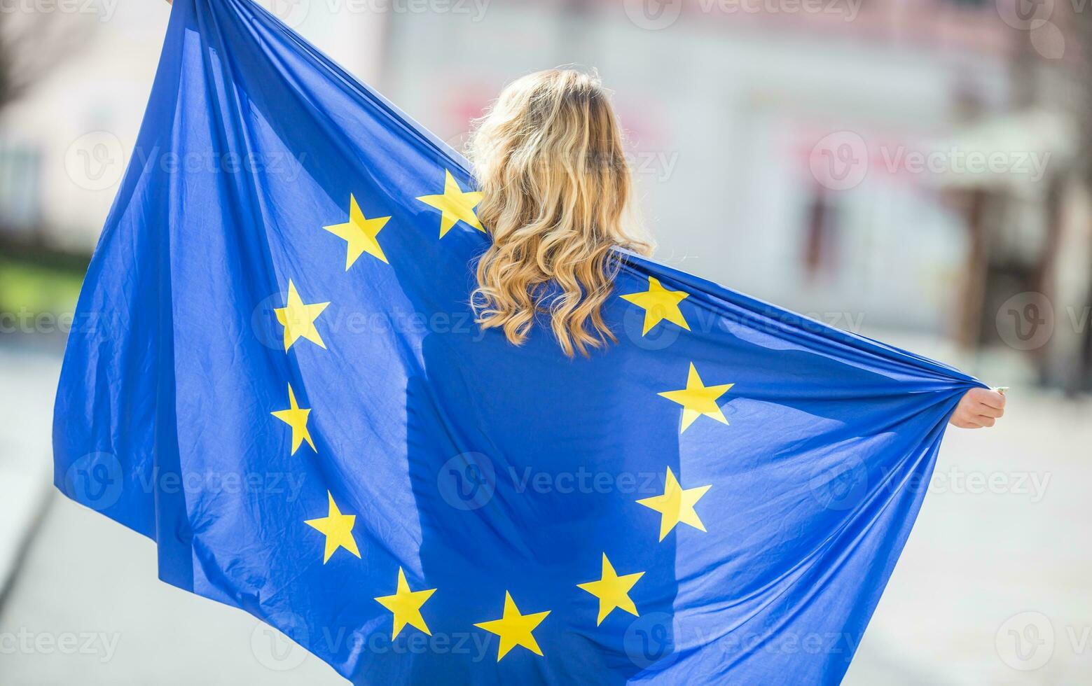 Attractive happy young girl with the flag of the European Union photo