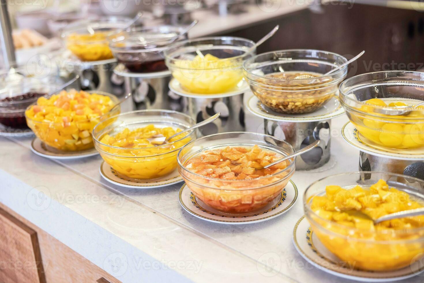 Fruit compotes in bowls on the buffet tables in the hotel restaurant photo