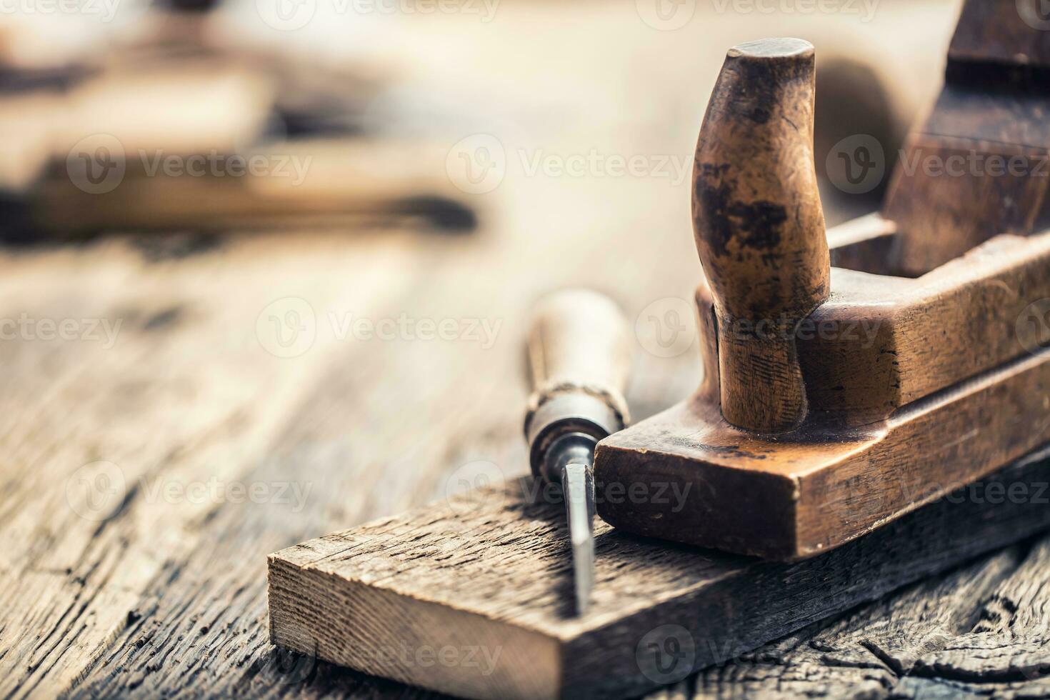 Old planer and other vintage carpenter tools in a carpentry workshop photo
