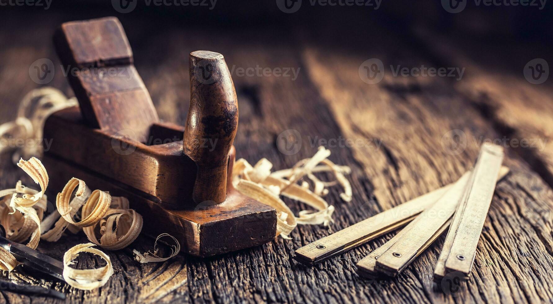 Old planer and other vintage carpenter tools in a carpentry workshop photo