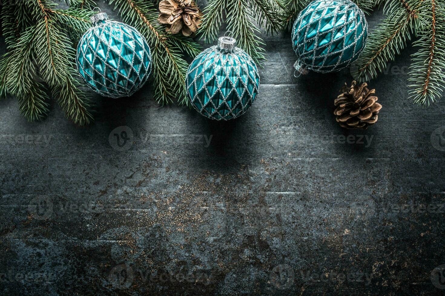 Top of view christmas balls fir tree pine cones on free concrete background photo