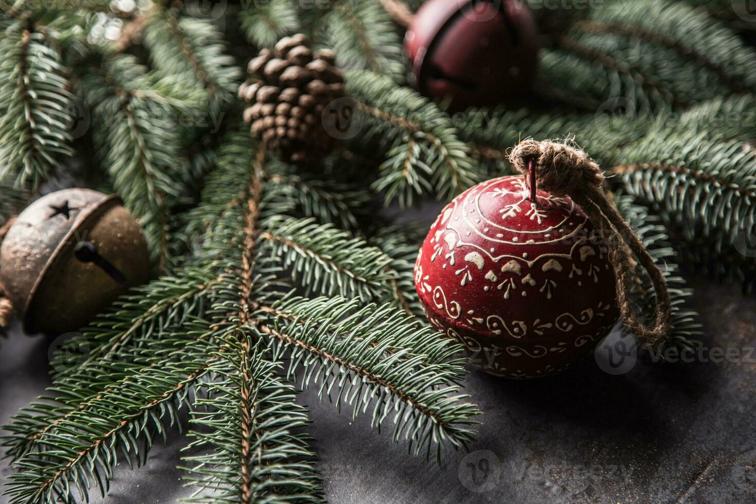 Top of view christmas decorations jingle bells fir tree pine cones on free concrete background photo