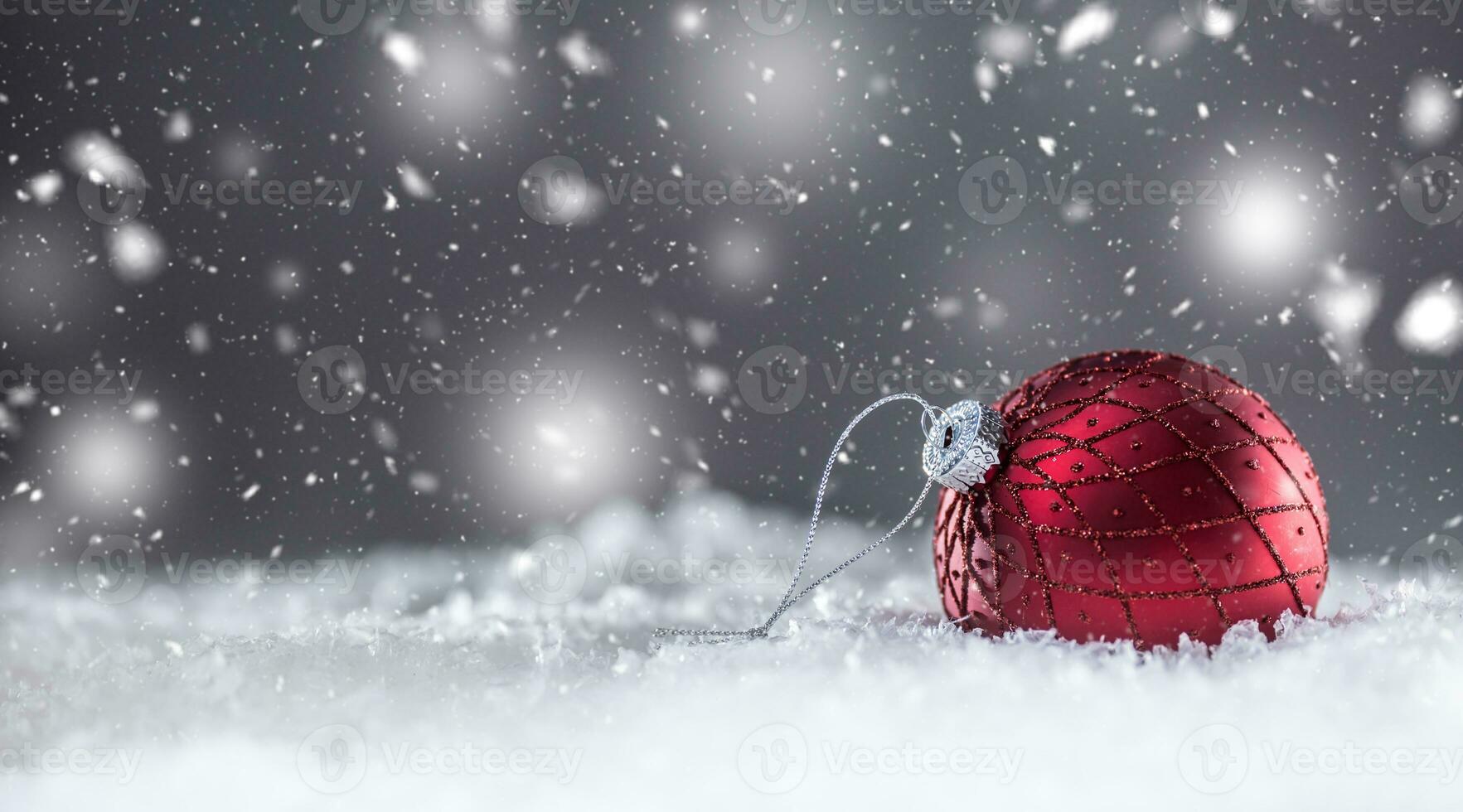 Christmas red Luxury ball in snow and abstract snowy atmosphere photo