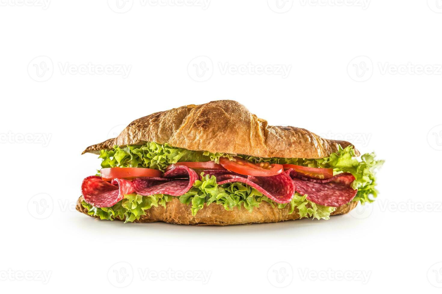 Croissant stuffed with lettuce salad salami and cheese isolated on white background photo