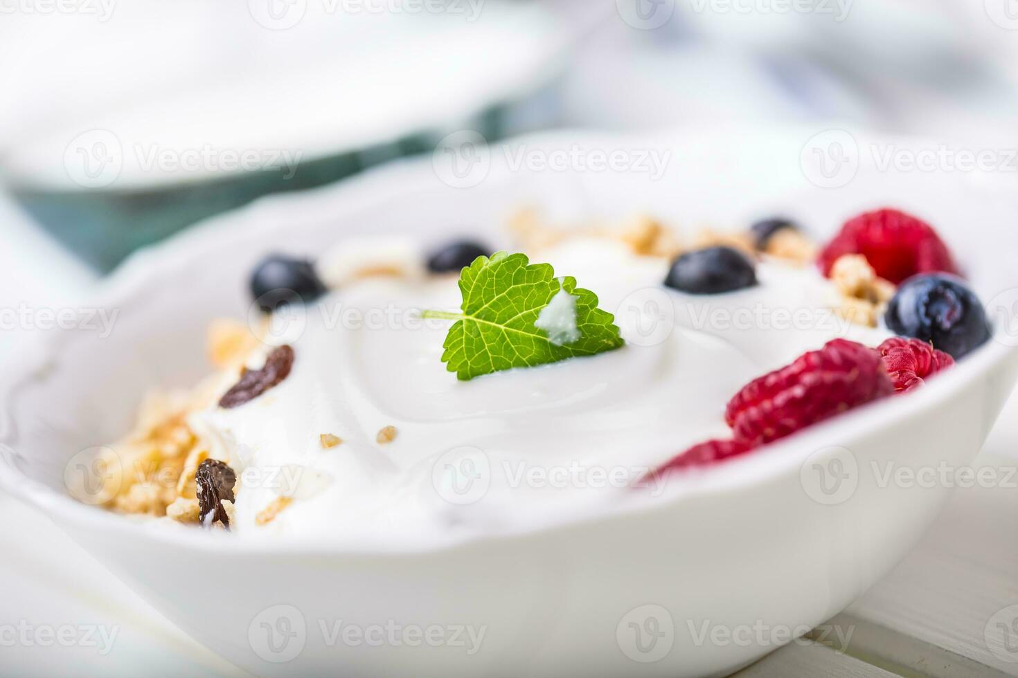 Muesli yoghurt and berries. Healthy breakfast with yogurt granola and fresh fruit photo