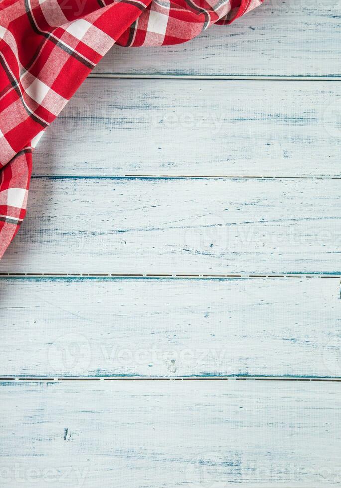 Top of view red checkered tablecloth on wooden table photo