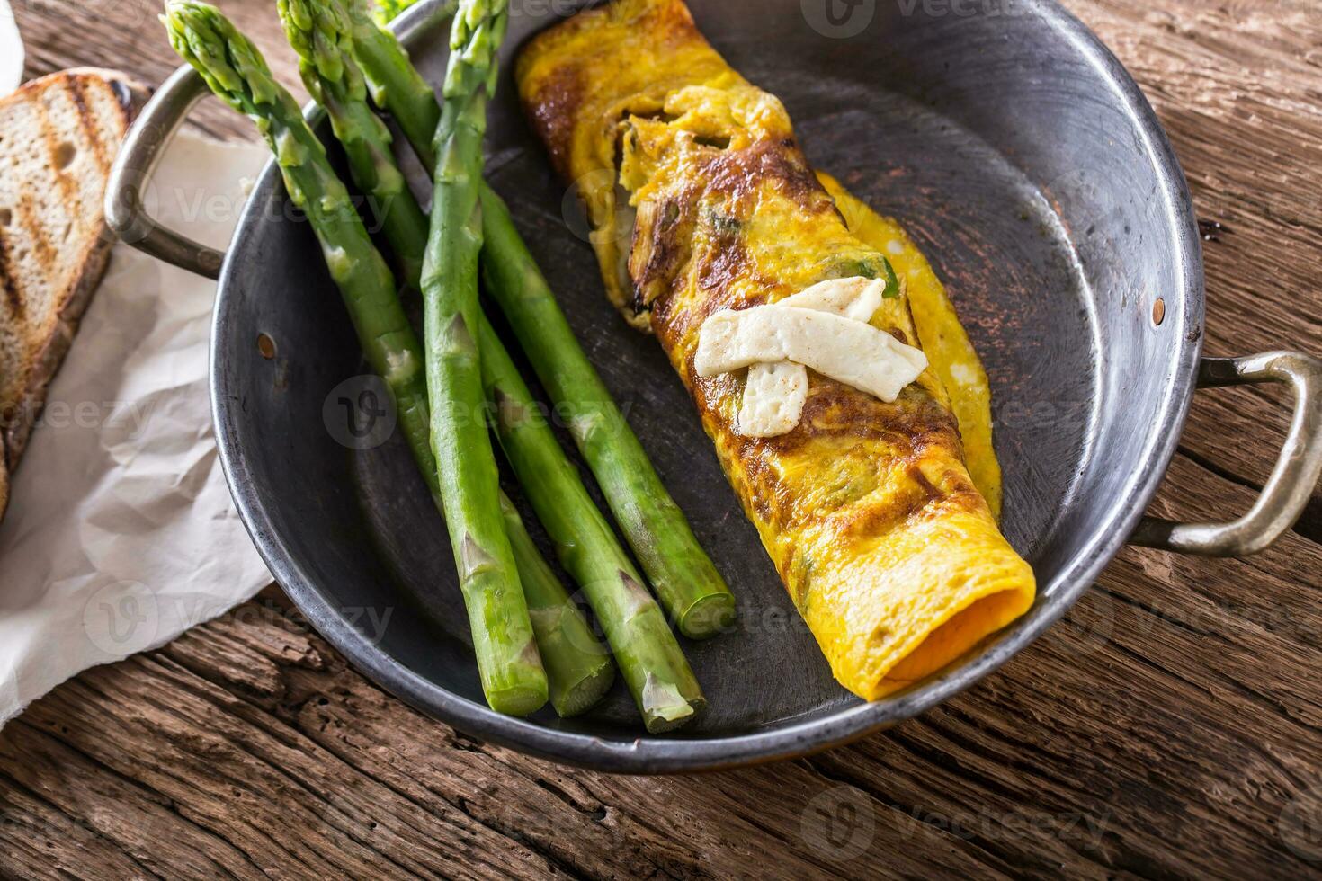 Asparagus and omelette.Omelette stuffed with asparagus  and cheese for a breakfast photo