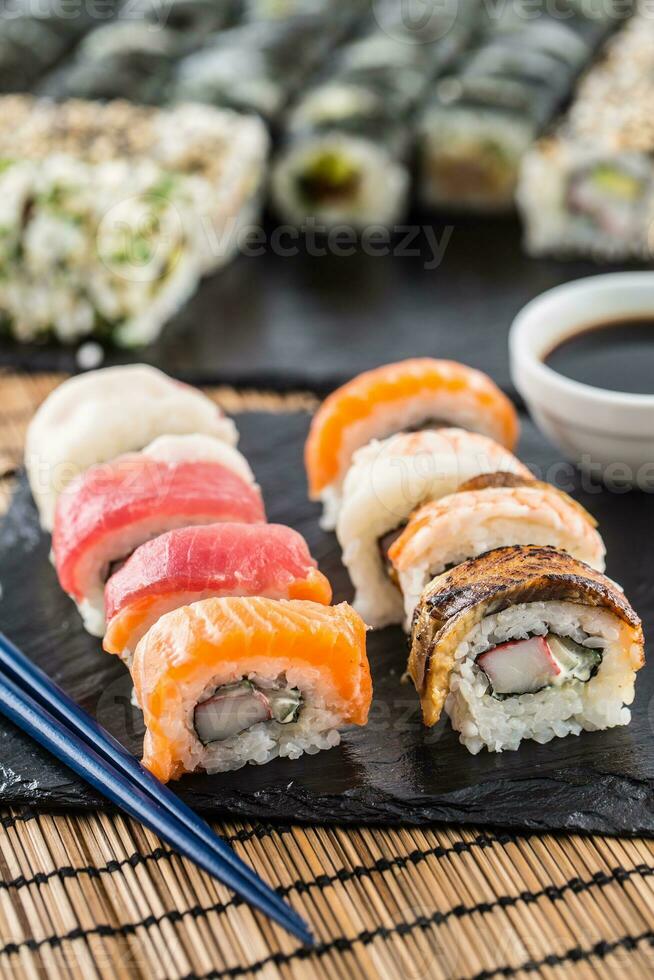 Set of roll sushi gold california with chopsticks and soy sauce. photo