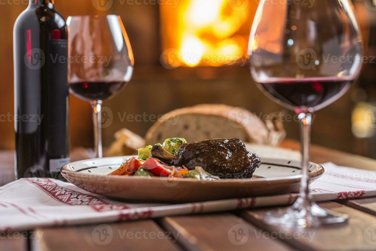 Confit rabbit leg with vegetable bread redvine in pub or restaur photo