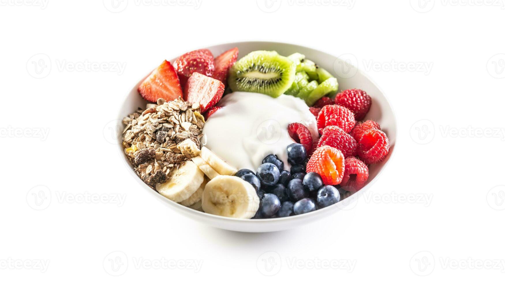 Fruit and yoghurt bowl with cereals, kiwi, strawberries, banana, blueberries and raspberries on isolated white background photo